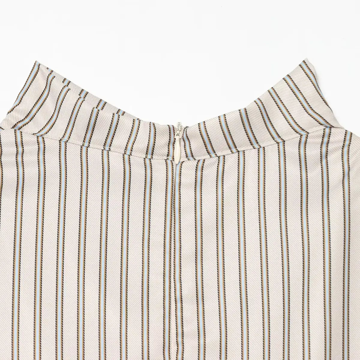 Close-up of the center back zipper on the striped dress, showing the high neckline closure