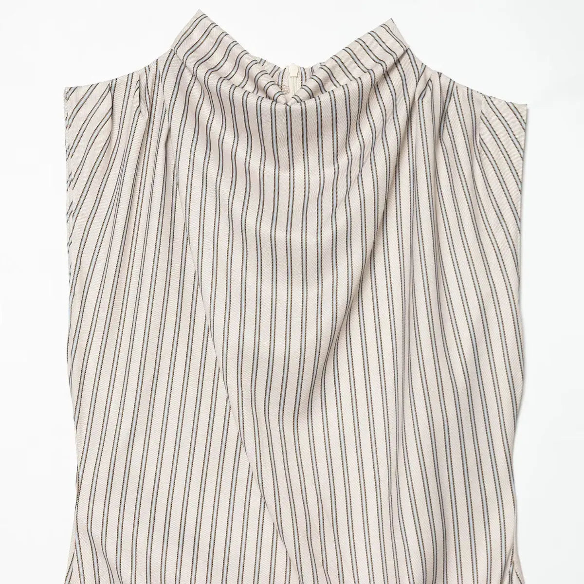 Close-up of the draped fabric on the front of the striped dress, showing the gathered design