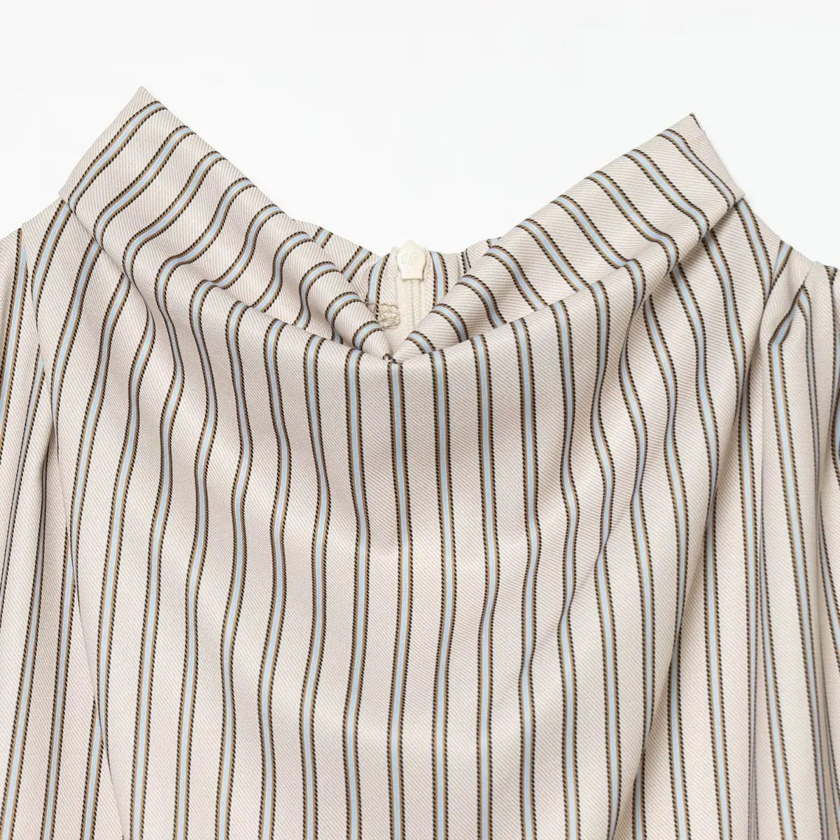 Close-up of the high neckline on the striped dress, showing the draped fabric and zipper pull