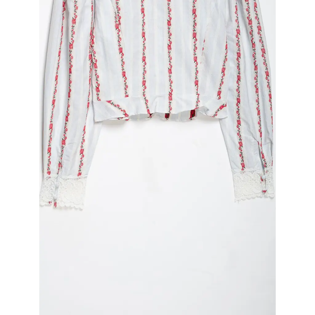 Close-up of back hem and lace cuffs flat lay