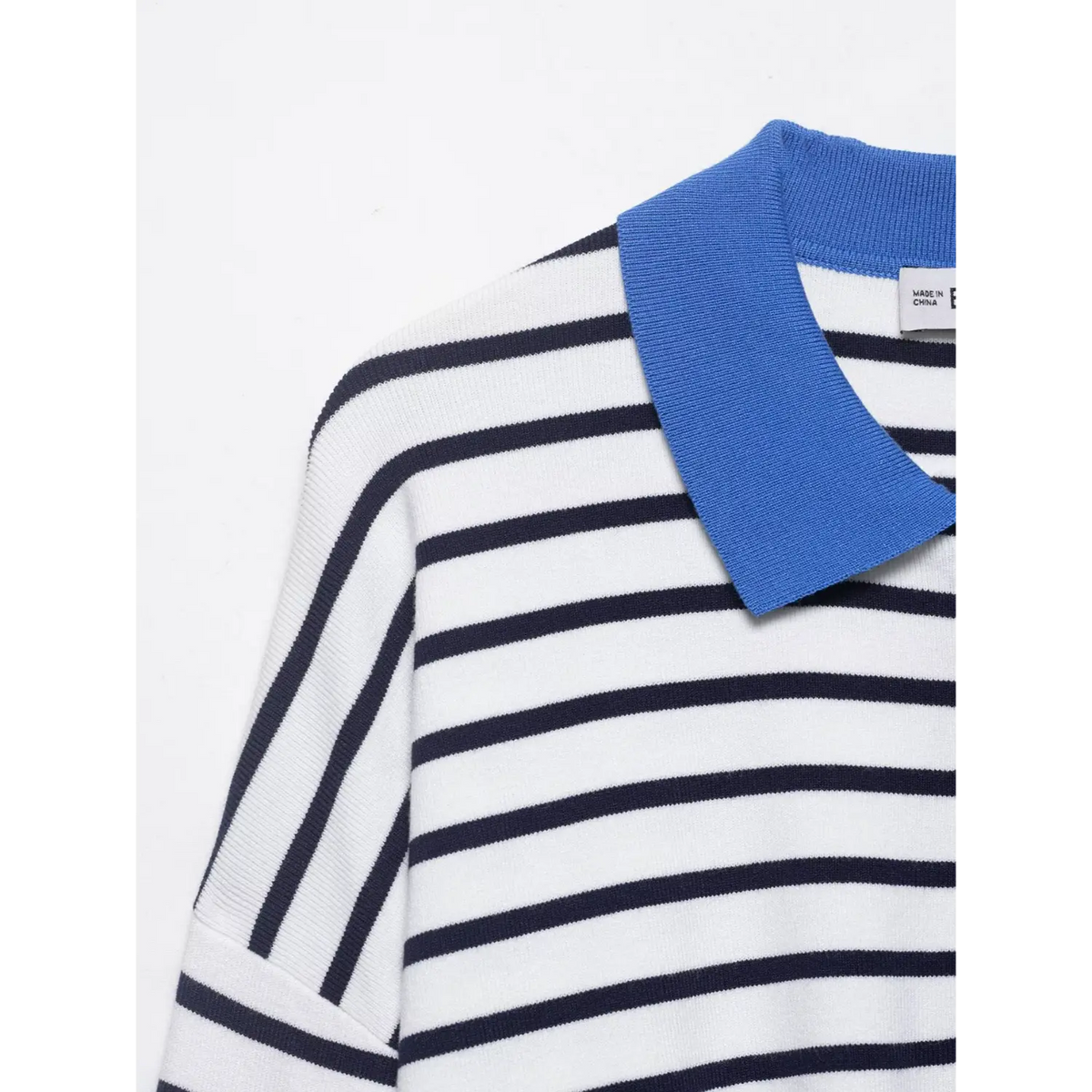 Close-up of blue spread collar and drop shoulder stripe