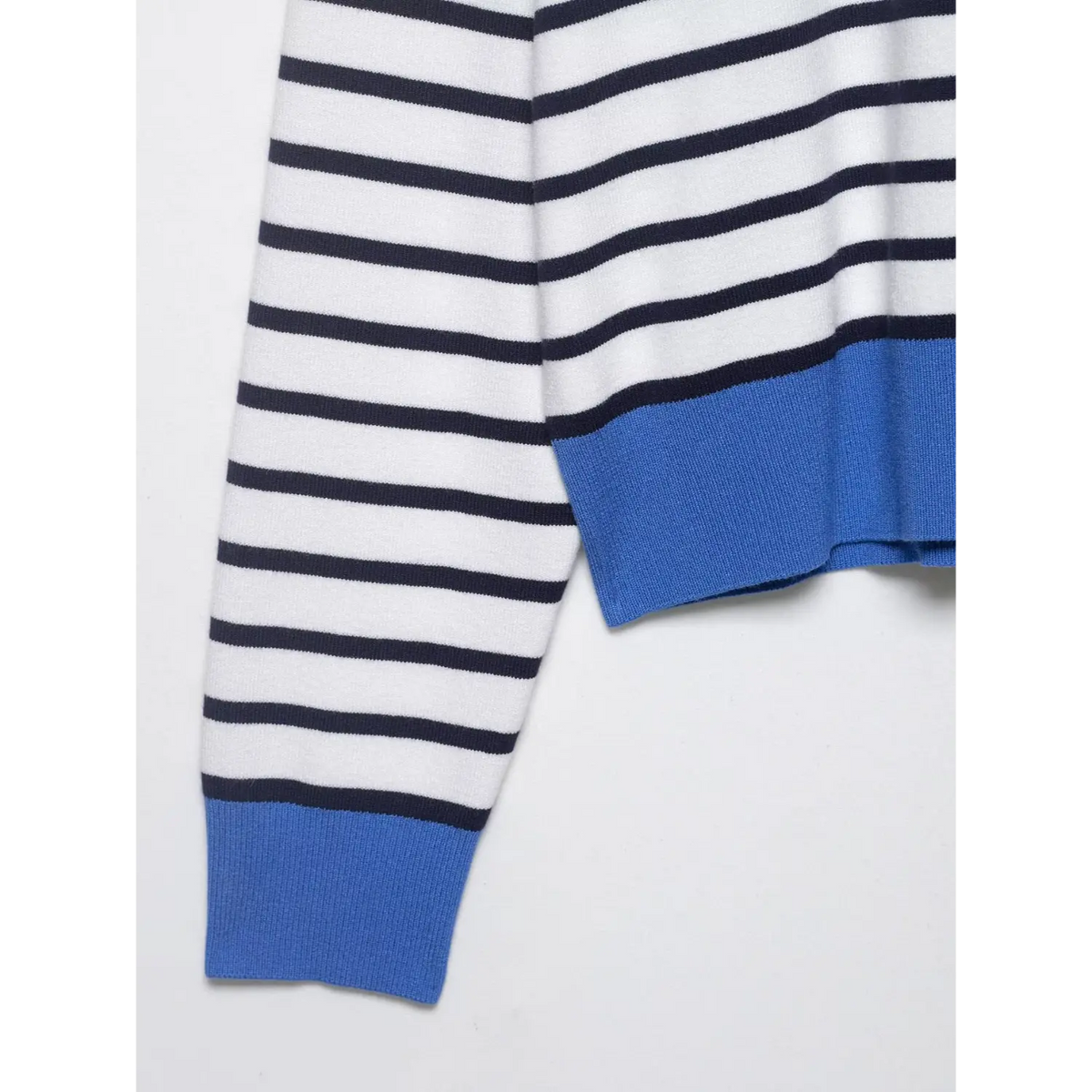 Close-up of blue ribbed hem and cuff with stripe pattern