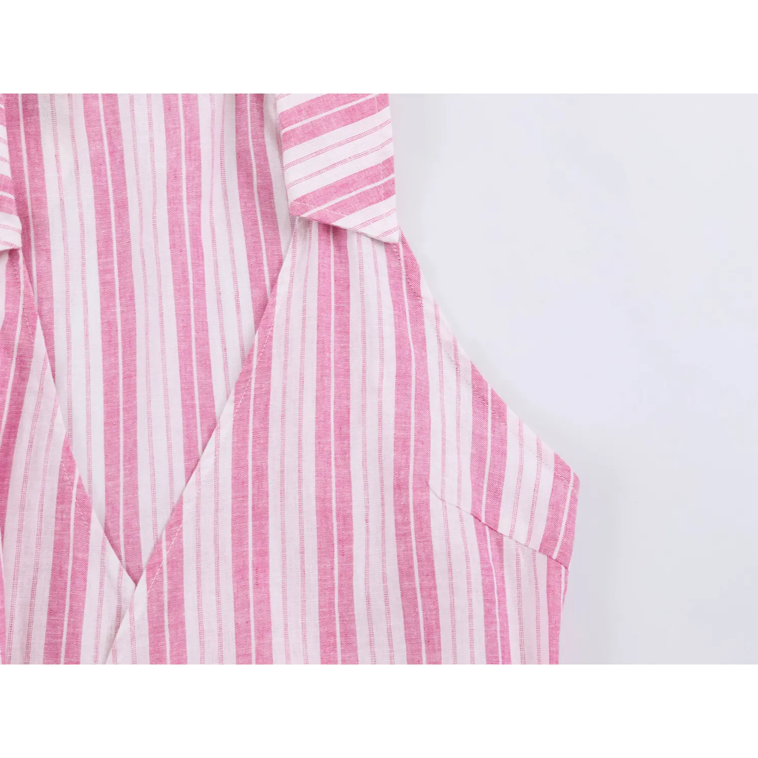 Close-up of armhole tailored seam and lapel collar structure on pink white woven stripe halter top