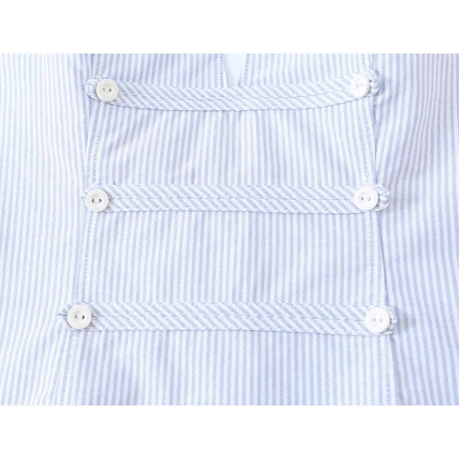 Front placket closeup, multi-row decorative buttons blue and white stripe halter crop top