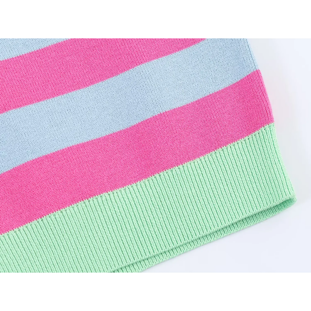 Close-up of pink and blue striped knit with mint green ribbed trim edge