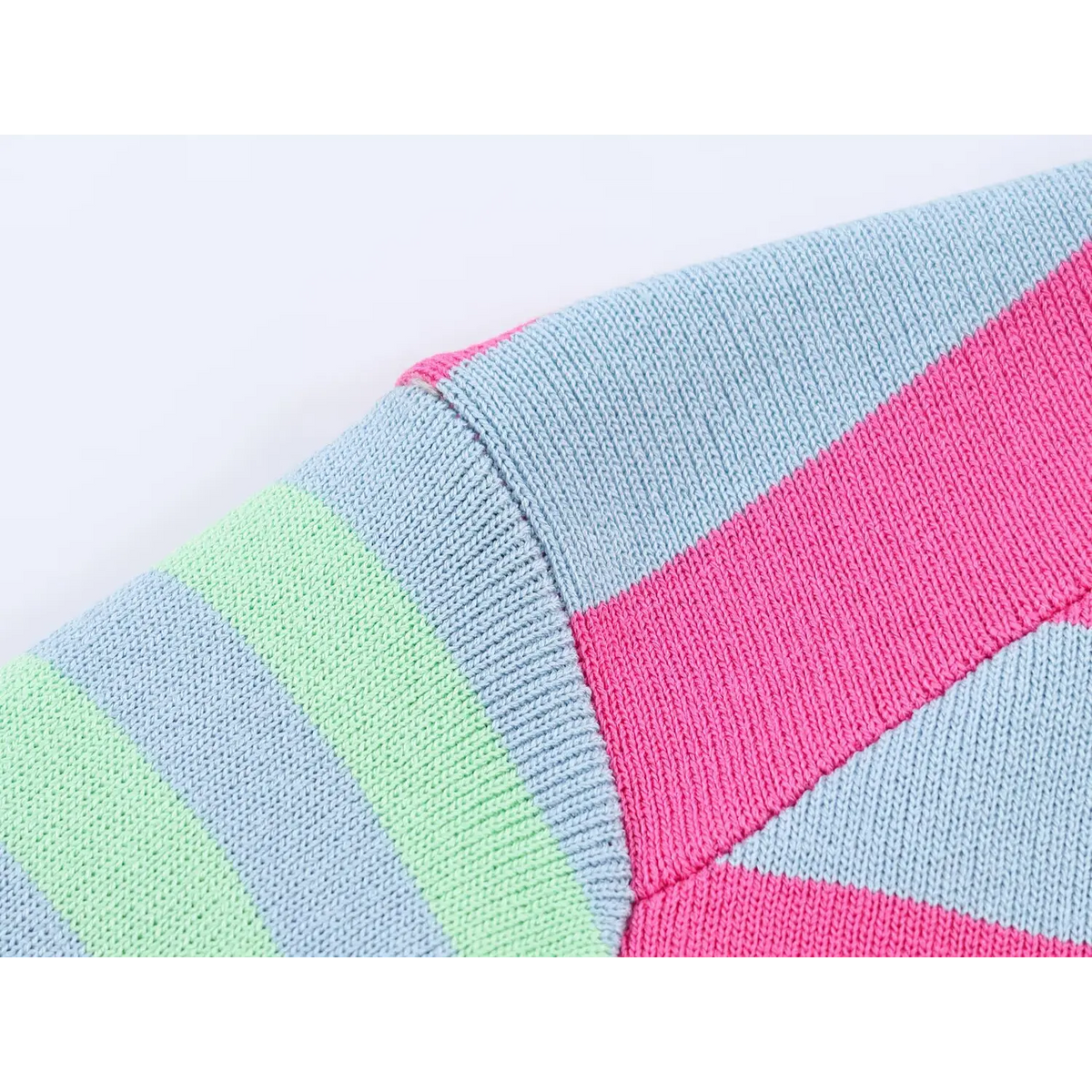 Close-up of pink, blue and mint stripe knit fabric with visible seams