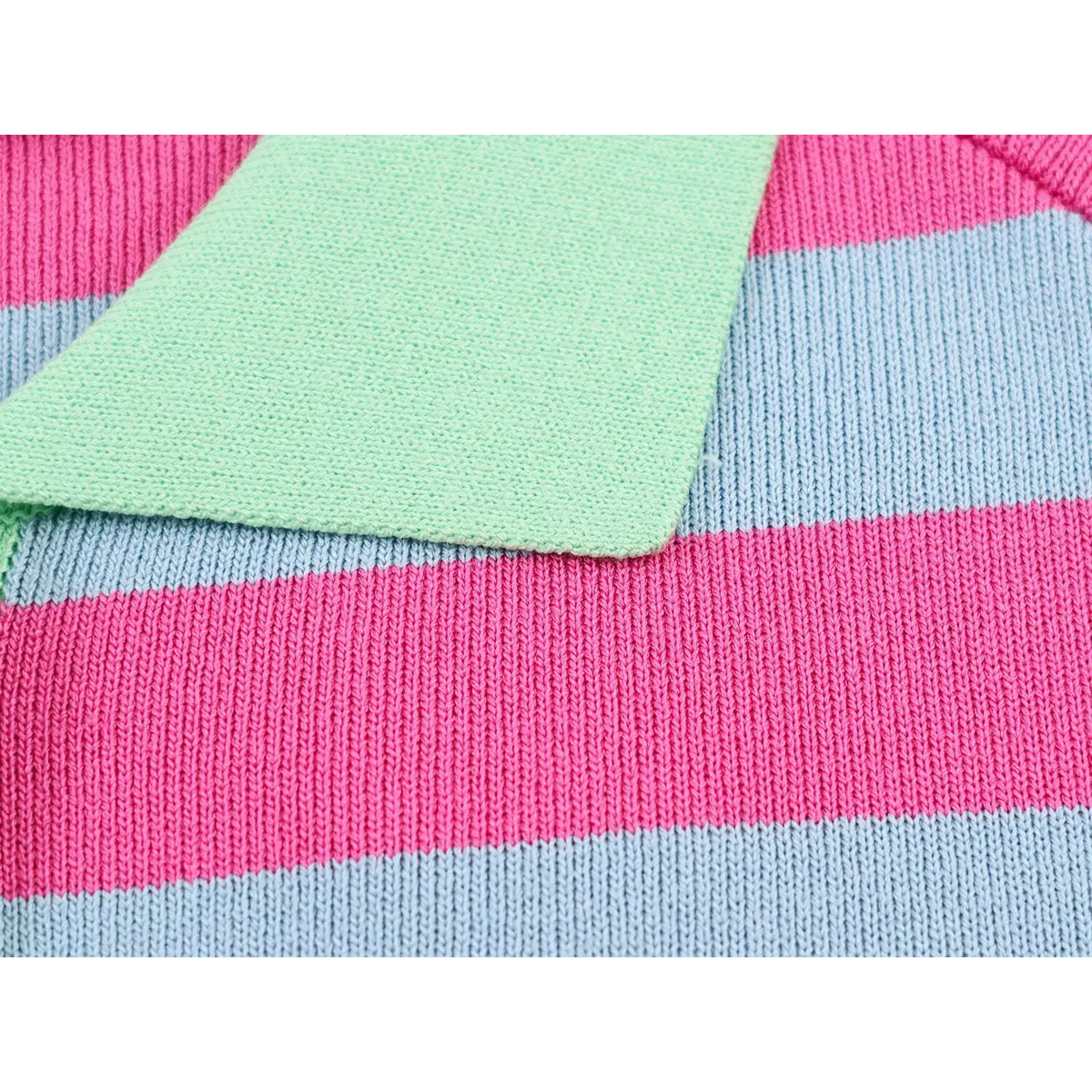 Close-up of pink and blue striped knit fabric layered with mint green knit