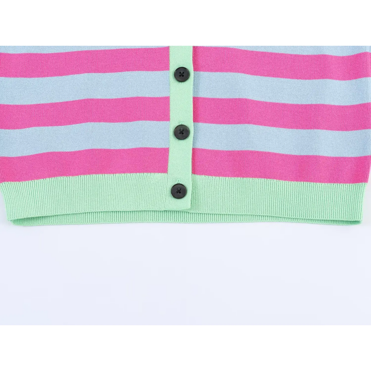 Close-up of mint green placket with three black buttons and ribbed hem on striped cardigan