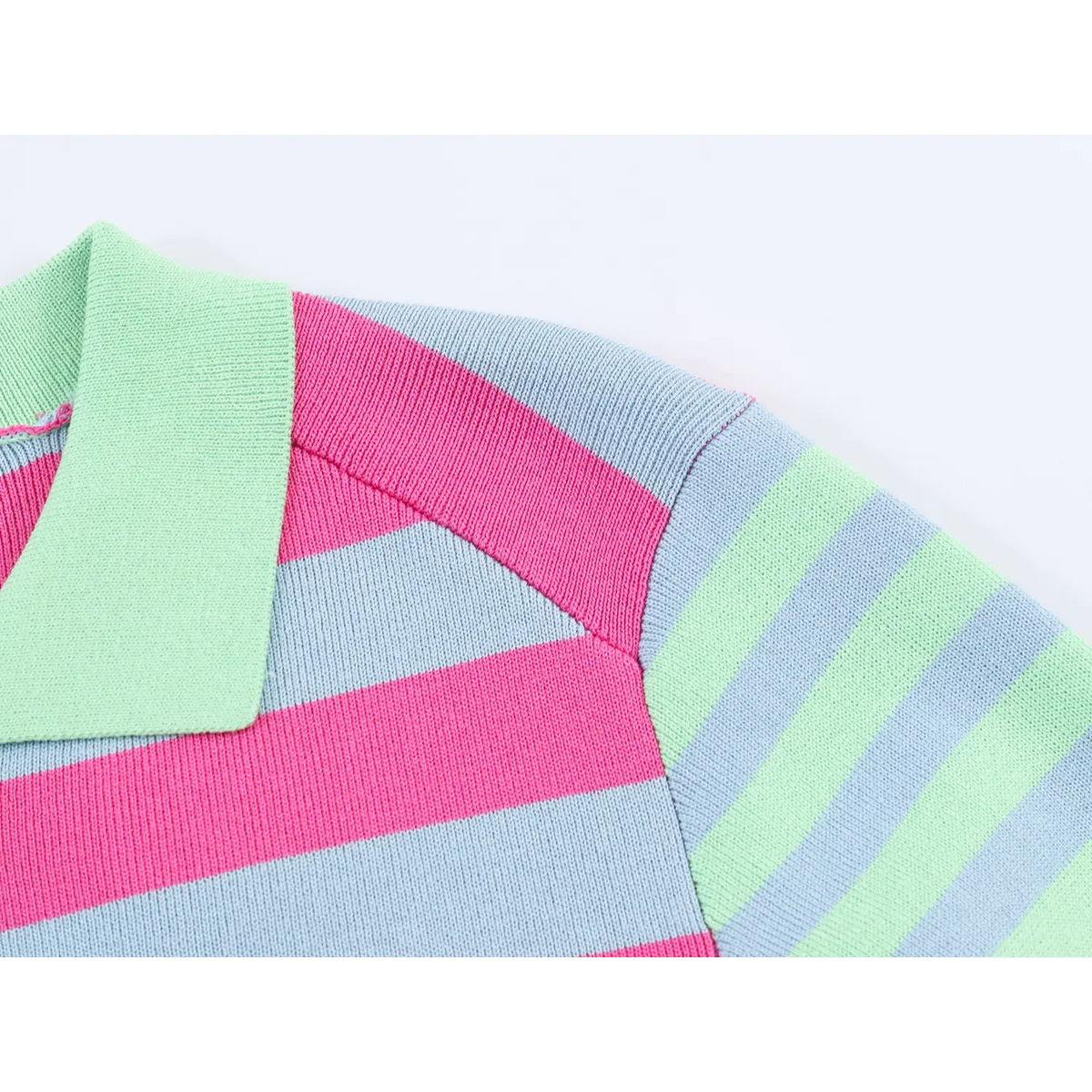 Close-up of mint green collar and shoulder seam on pink blue striped knit cardigan