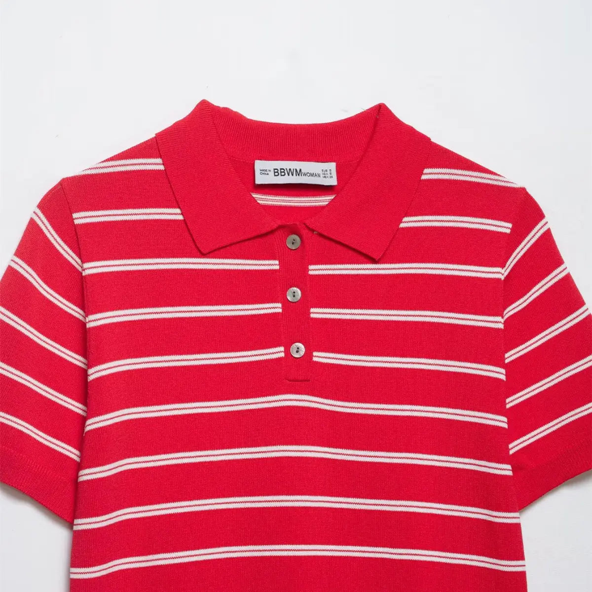 Front view of the red and white striped knit polo shirt, showing the placket buttons, ribbed collar, and horizontal stripes