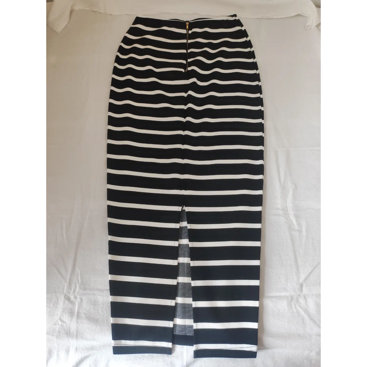 Flat lay back view striped pencil skirt featuring rear center slit