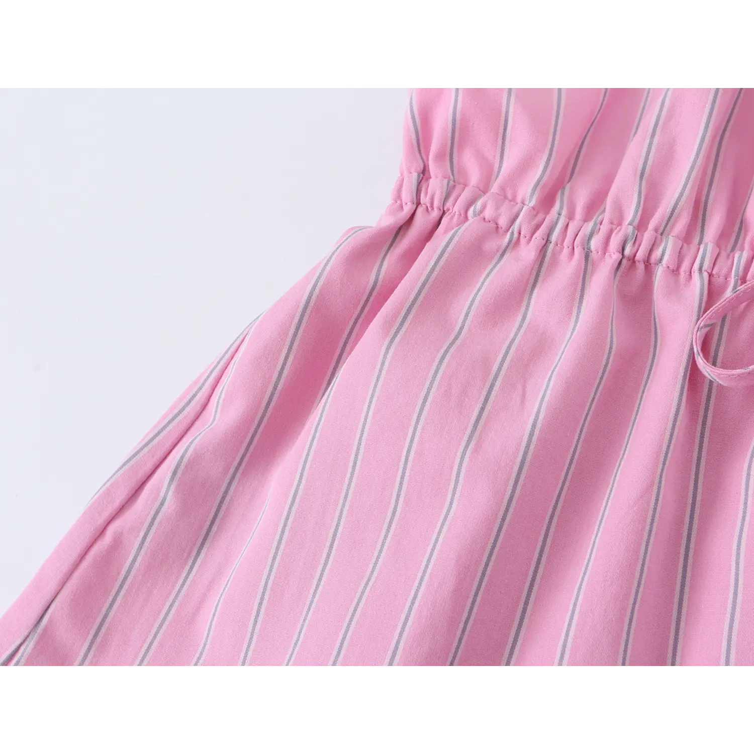 Partial shot of elastic waist gathering and flared peplum hem, lightweight woven stripe fabric