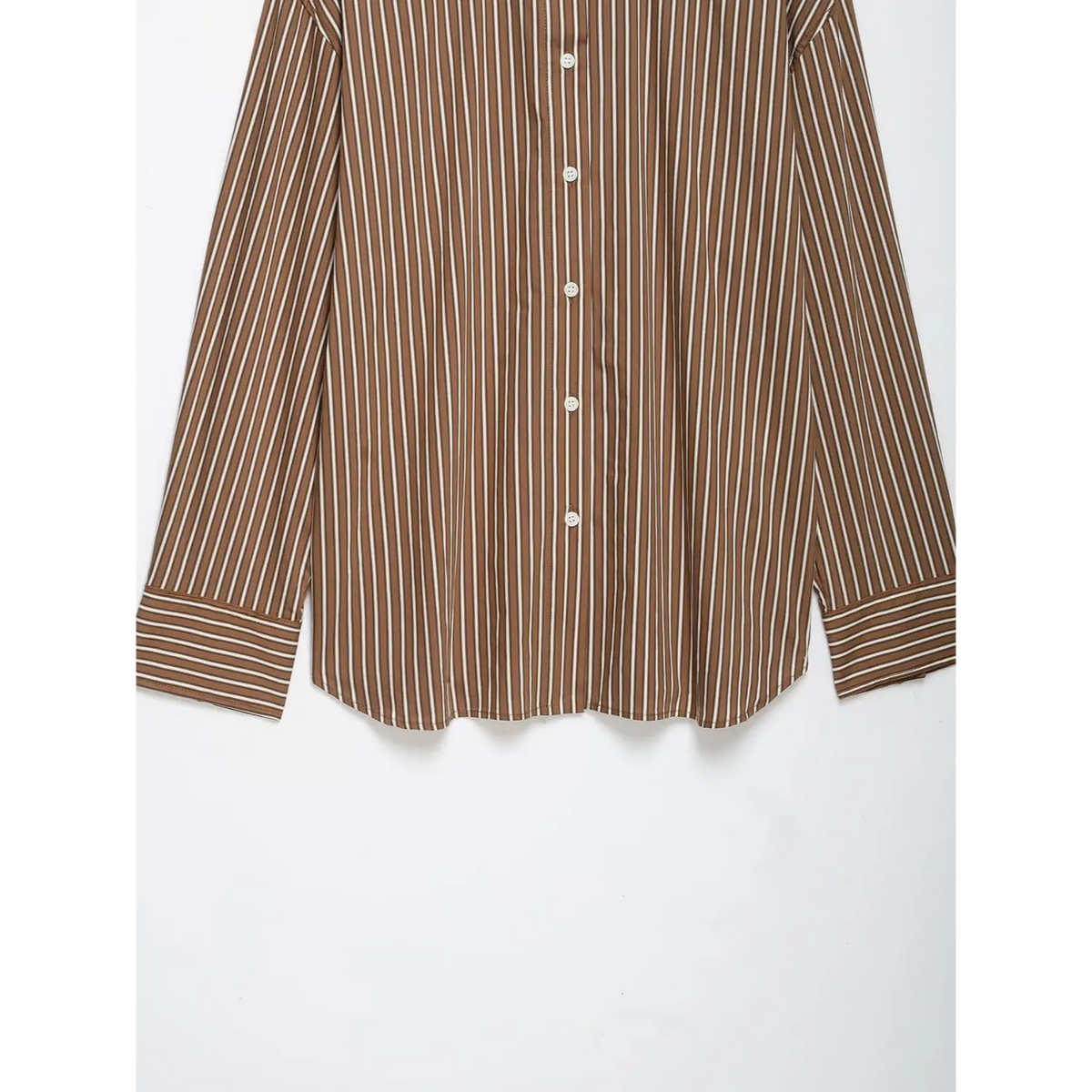 Close-up of front white buttons and curved hem