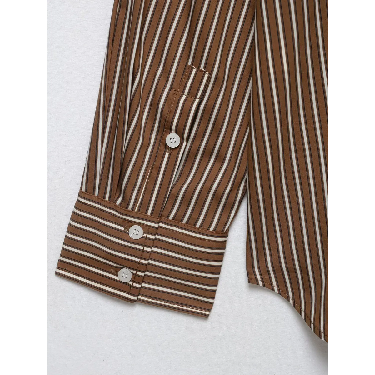 Close-up of cuff buttons and contrast striped cuff