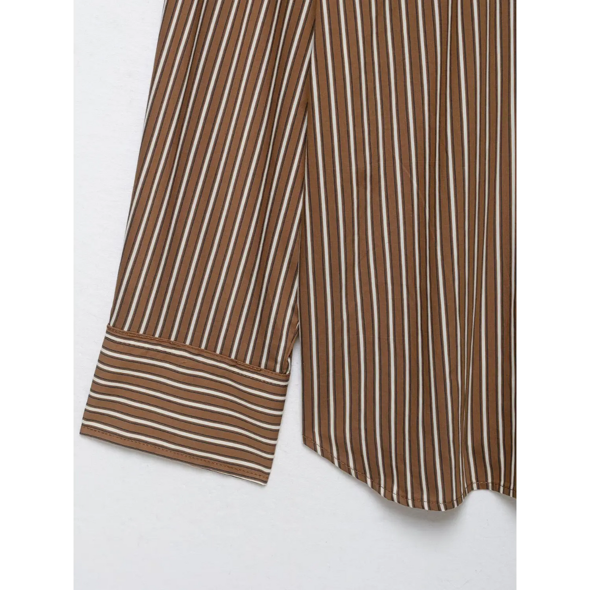 Close-up of contrast striped cuff and curved hem