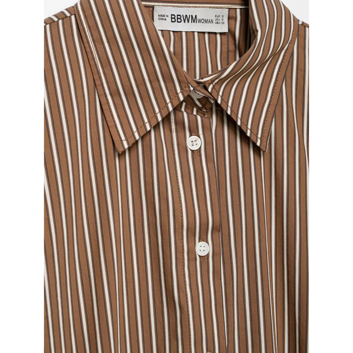 Close-up of collar label and top button detail
