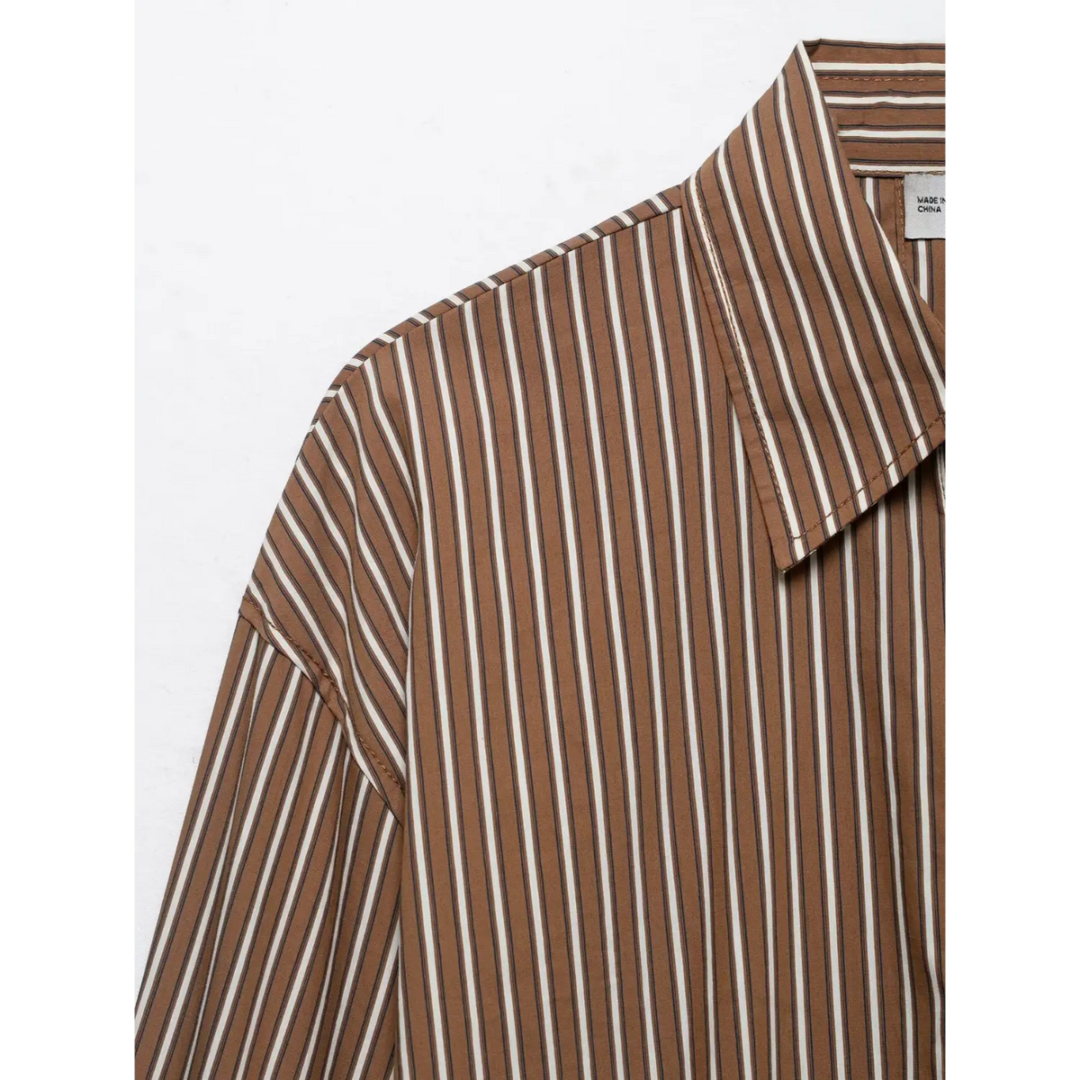 Close-up of point collar, drop shoulder and vertical stripe fabric