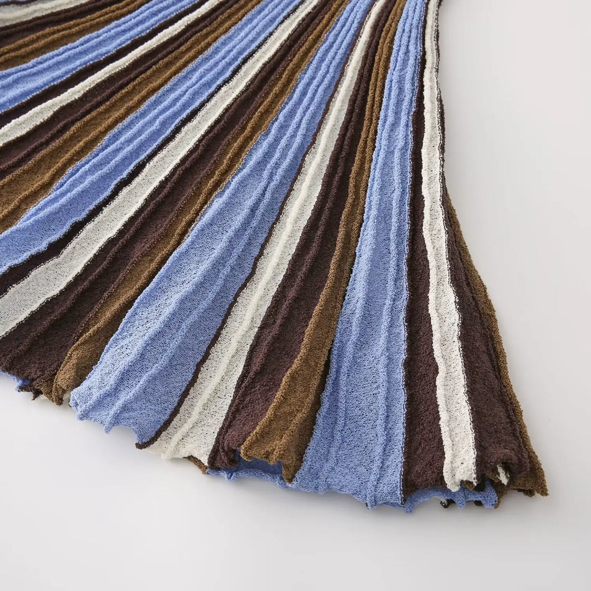 Close-up of blue brown striped flared skirt hem