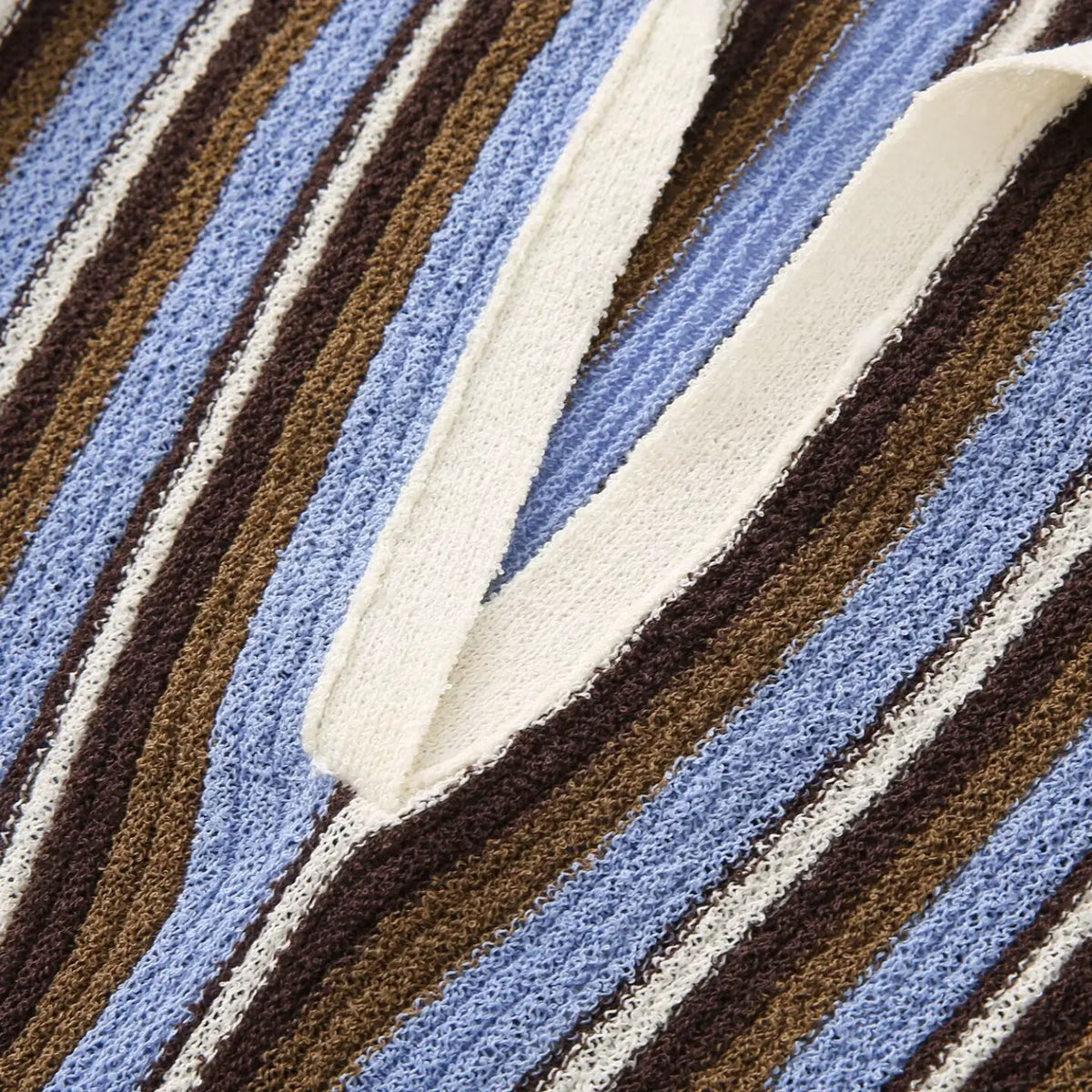 Close-up of blue brown striped V placket detail