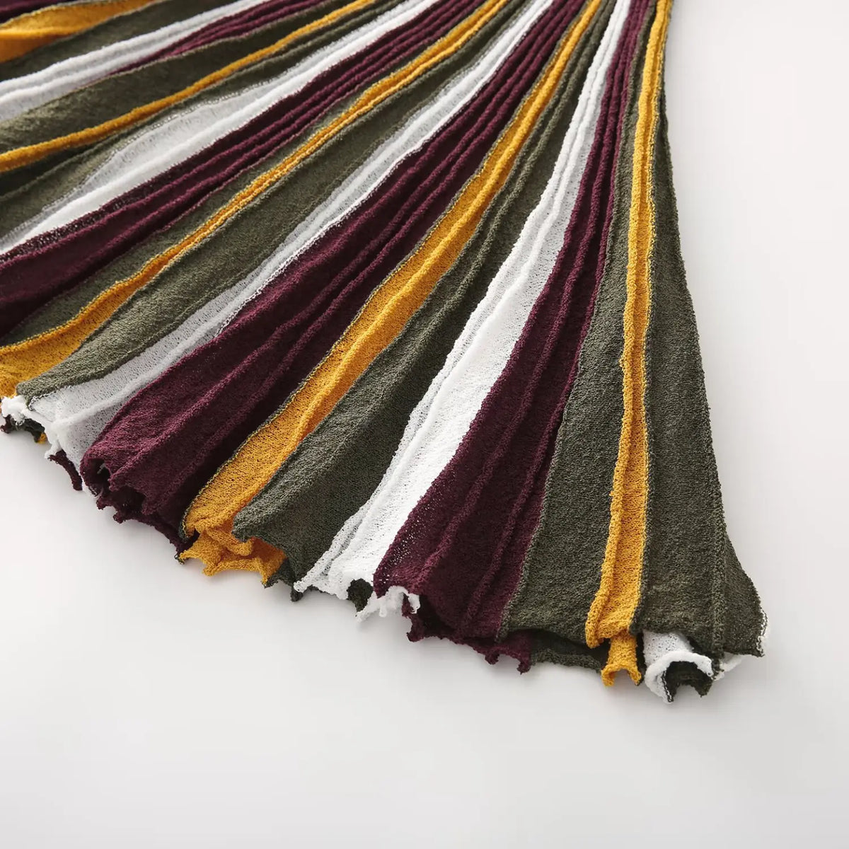 Close-up of burgundy olive striped flared skirt hem
