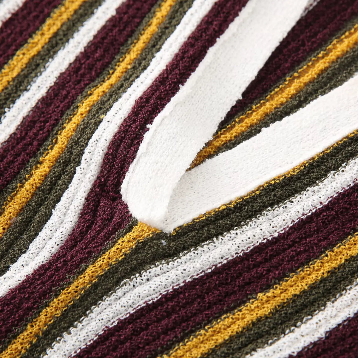 Close-up of burgundy olive striped V placket detail