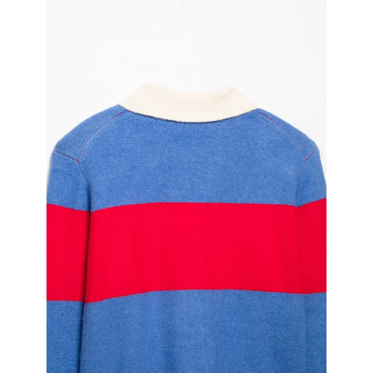 Close-up of back of knit top with off-white collar, blue body and wide red stripe