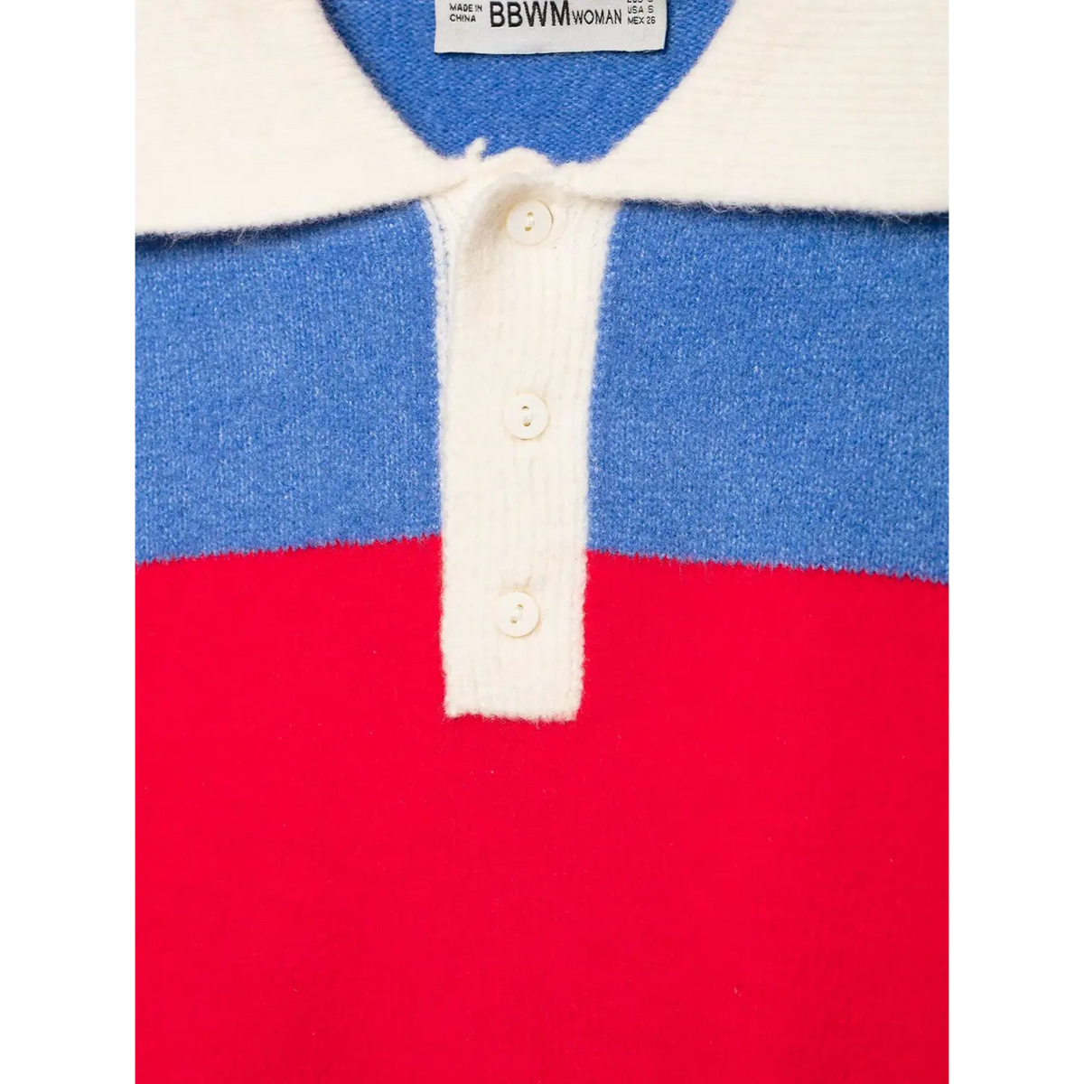 Close-up of collar and placket with three cream buttons and woven label on striped knit top