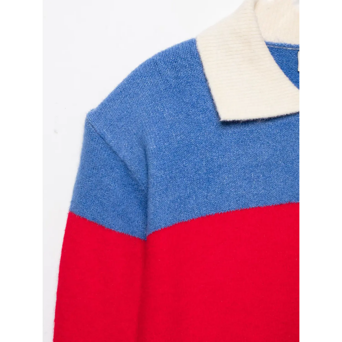Close-up of off-white polo collar and shoulder on blue and red color blocked knit top
