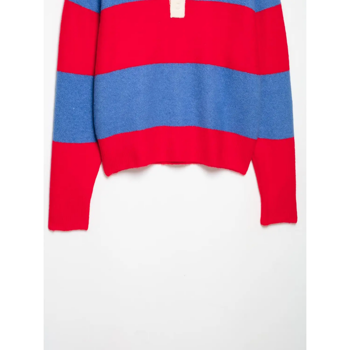 Flat lay of striped polo knit top with red and blue horizontal stripes, button placket and red ribbed hem