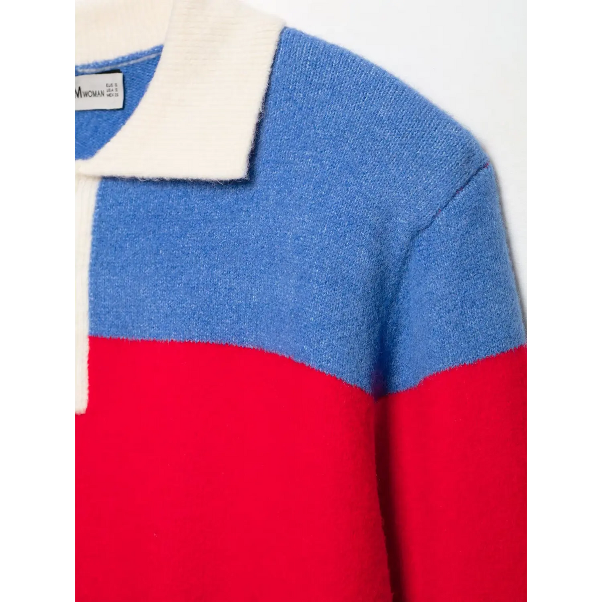 Close-up of white polo collar and color blocked bodice in royal blue and red knit