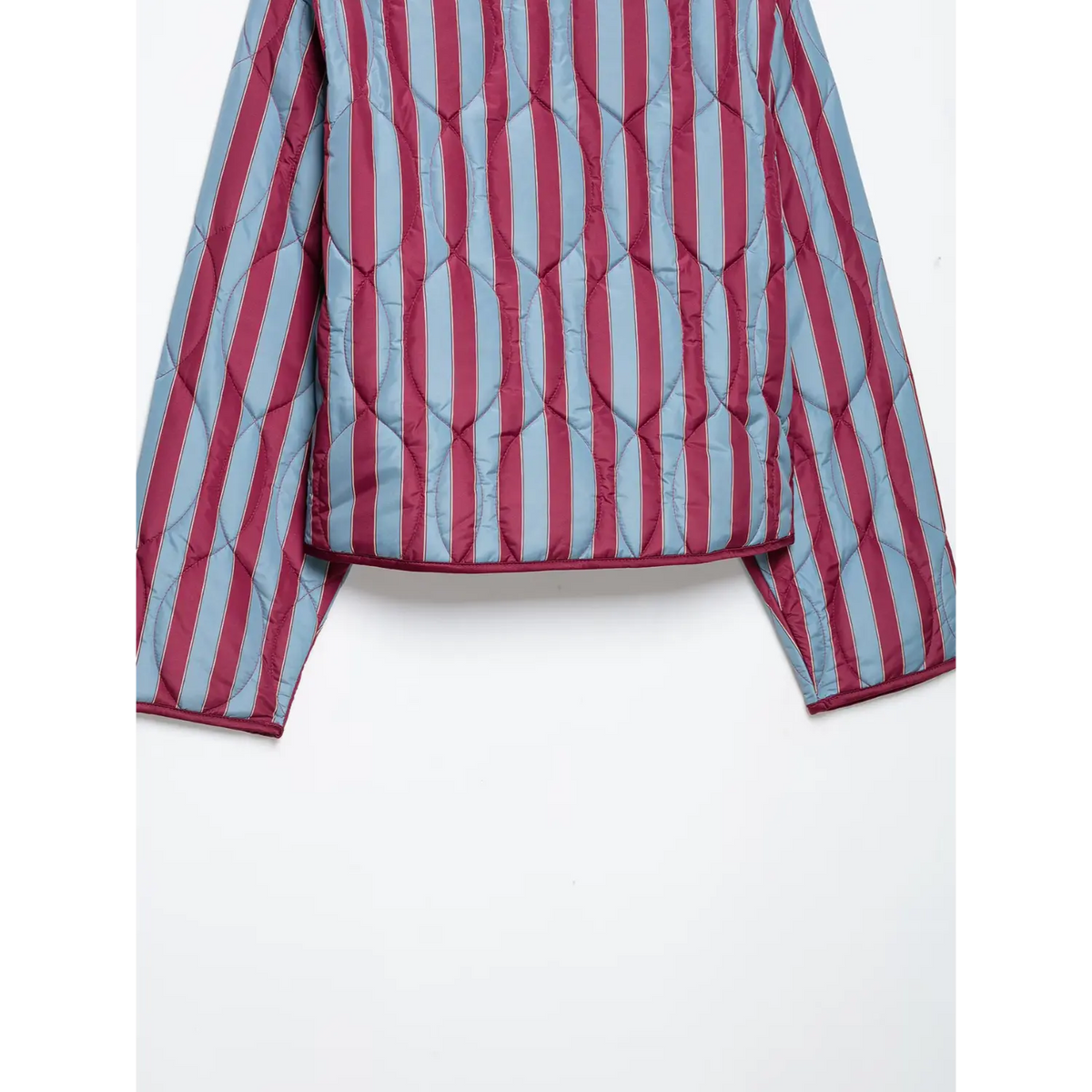 Close-up of back hem and diamond quilted stitch on striped jacket