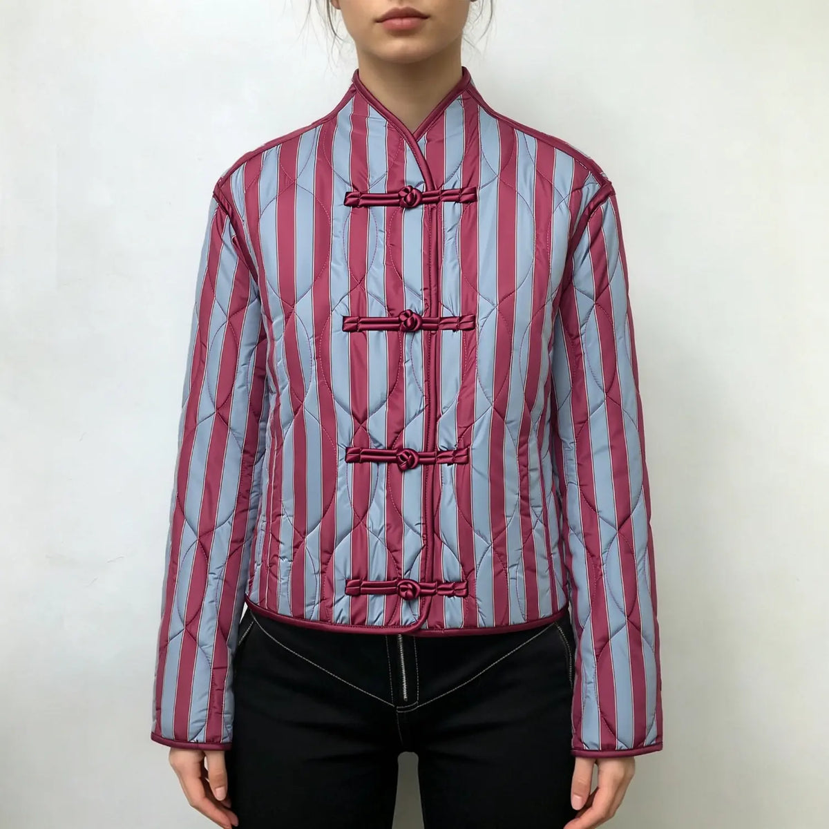 Model wearing striped quilted jacket with mandarin collar and black trousers