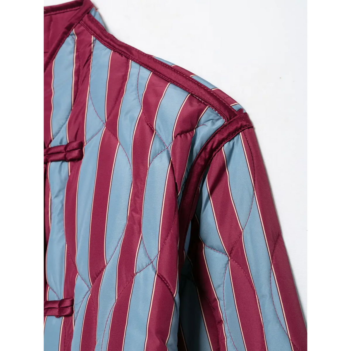Close-up of shoulder seam and binding on striped quilted jacket