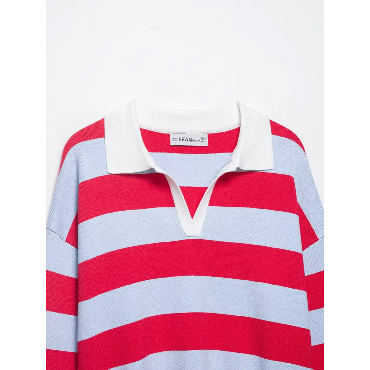 Close-up of white collar, V neck opening and inner label