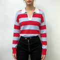 Model wearing striped V neck collared knit top with black high waist trousers