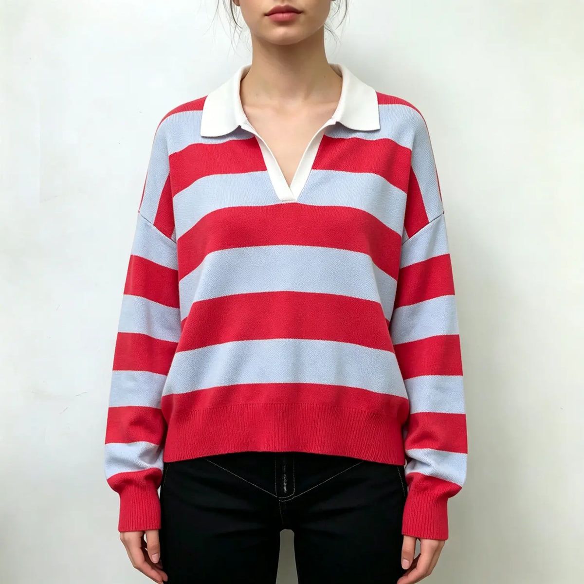 Model wearing striped V neck collared knit top with black trousers