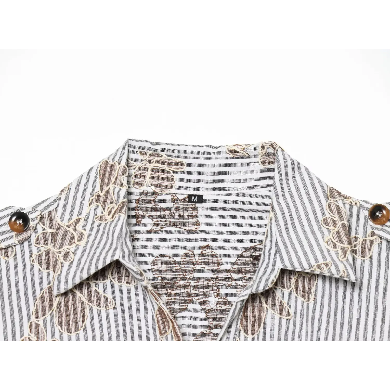 Macro close‑up of shirt collar, inner size tag and mixed stripe floral fabric texture