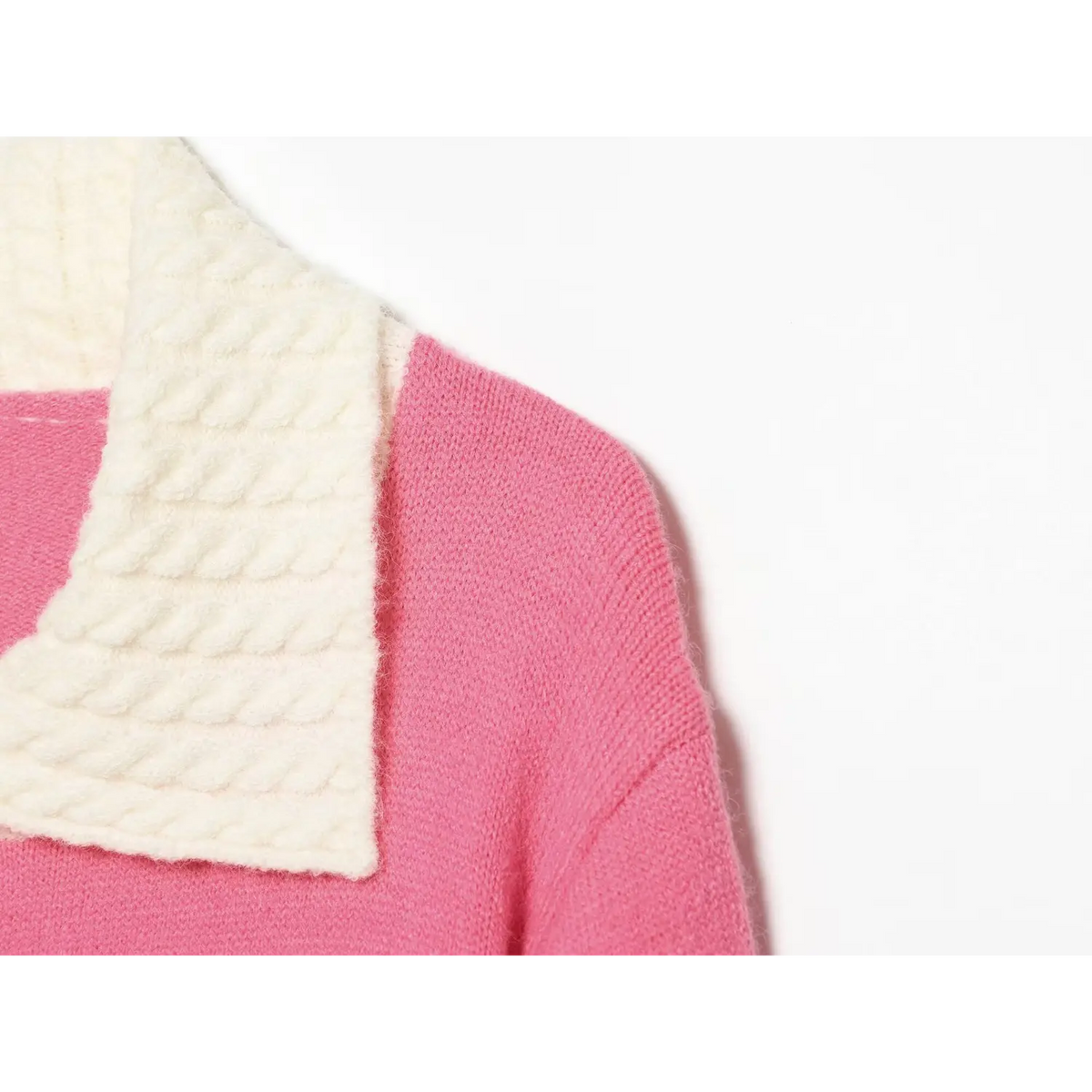 Shoulder closeup, pink knit cardigan with white cable woven lapel collar