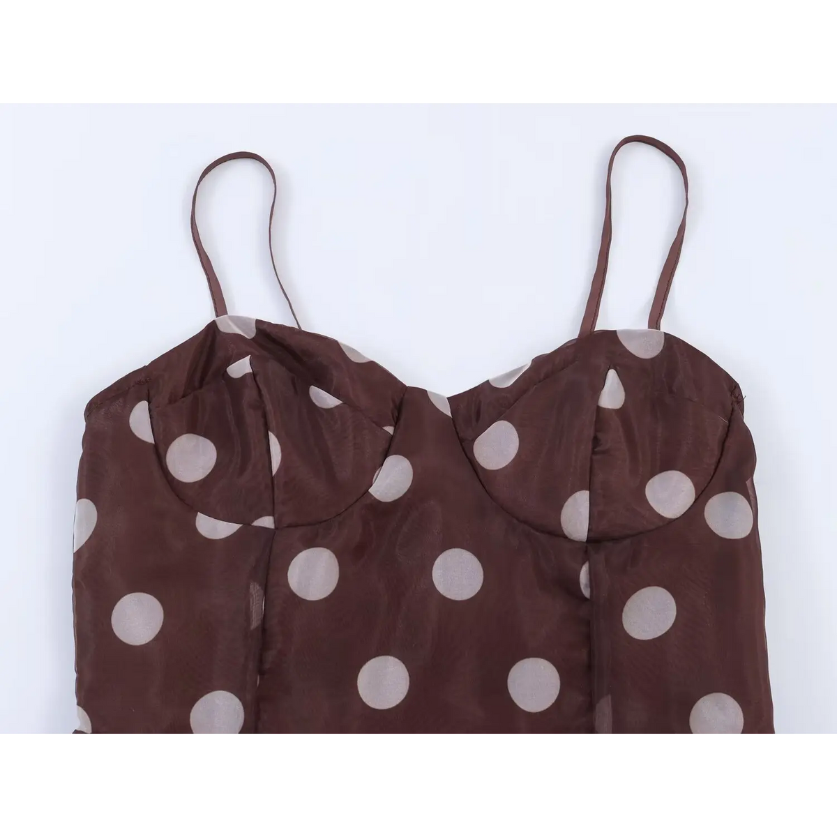 Close-up of sweetheart neckline and structured bust cups on brown white polka dot maxi dress
