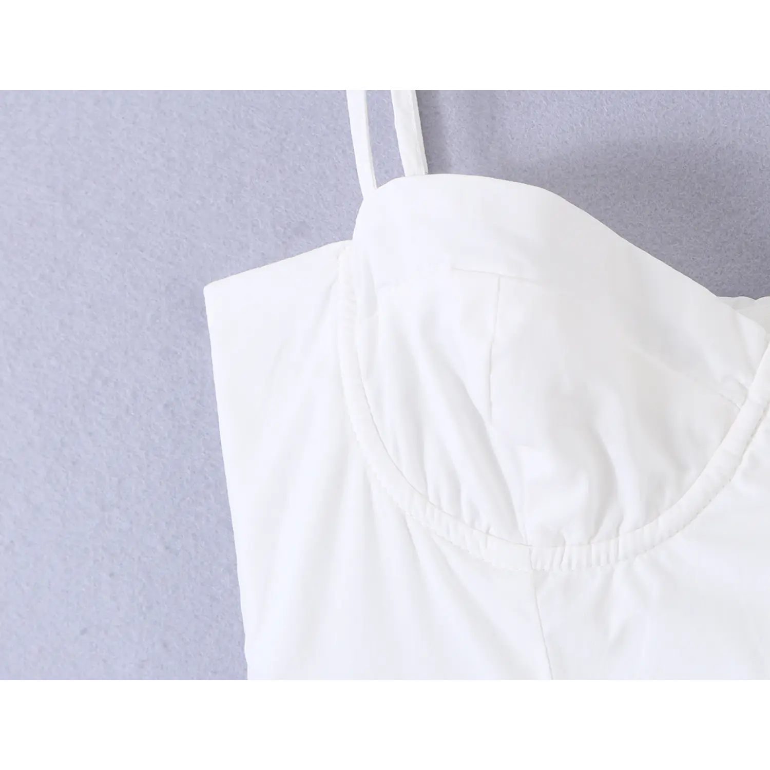 Fabric stitching detail of sweetheart bust cup on white spaghetti strap mini dress