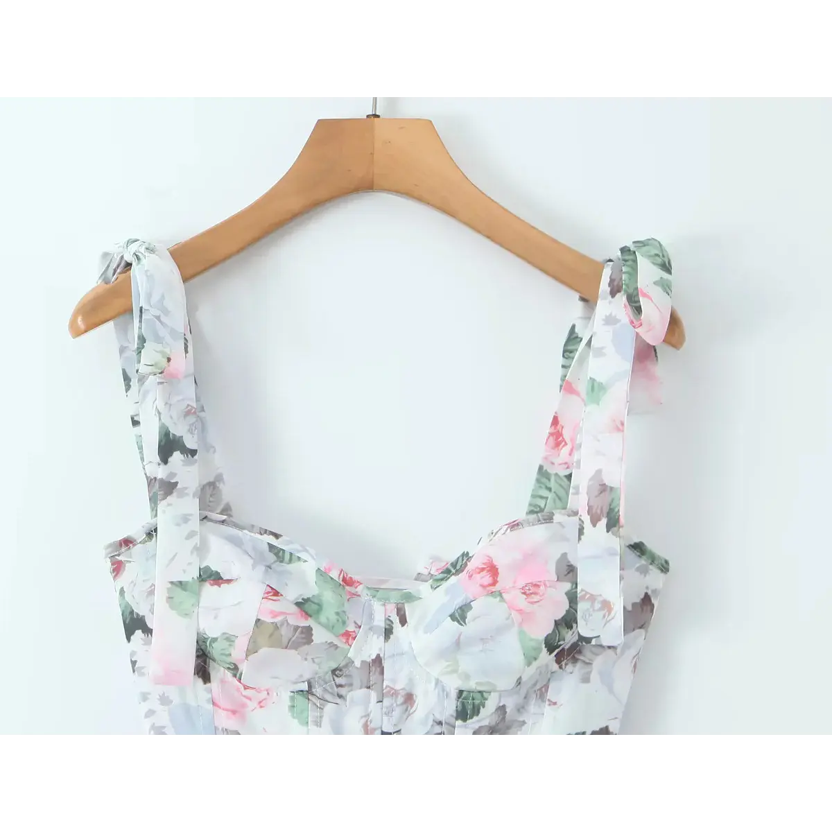 Close-up of the sweetheart neckline and structured corset bodice on a floral print dress.