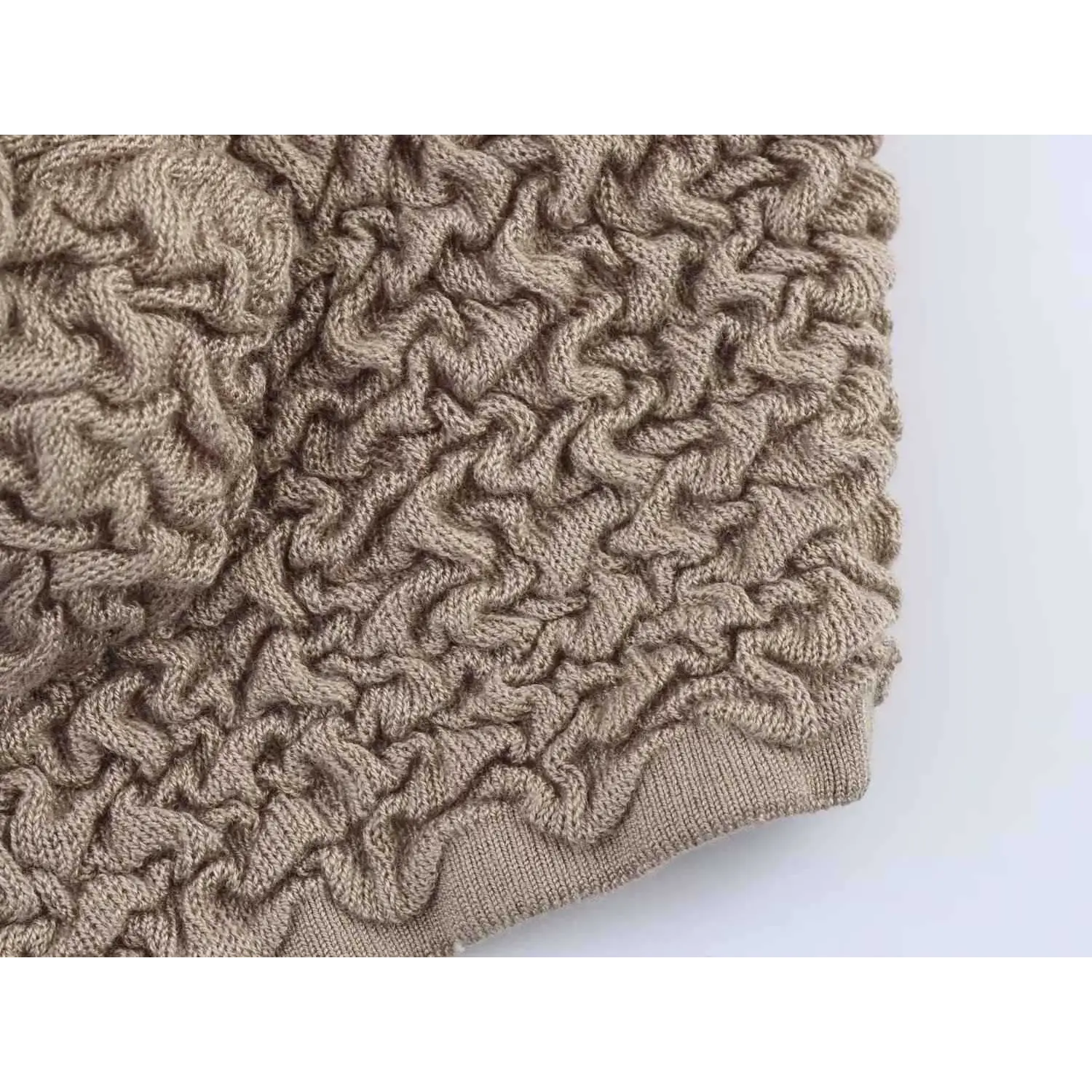 Macro shot of textured bubble knit fabric showing its puffy, crinkled surface