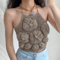 Lifestyle wearing shot of taupe textured bubble knit camisole top with floral pattern, paired with light blue denim jeans