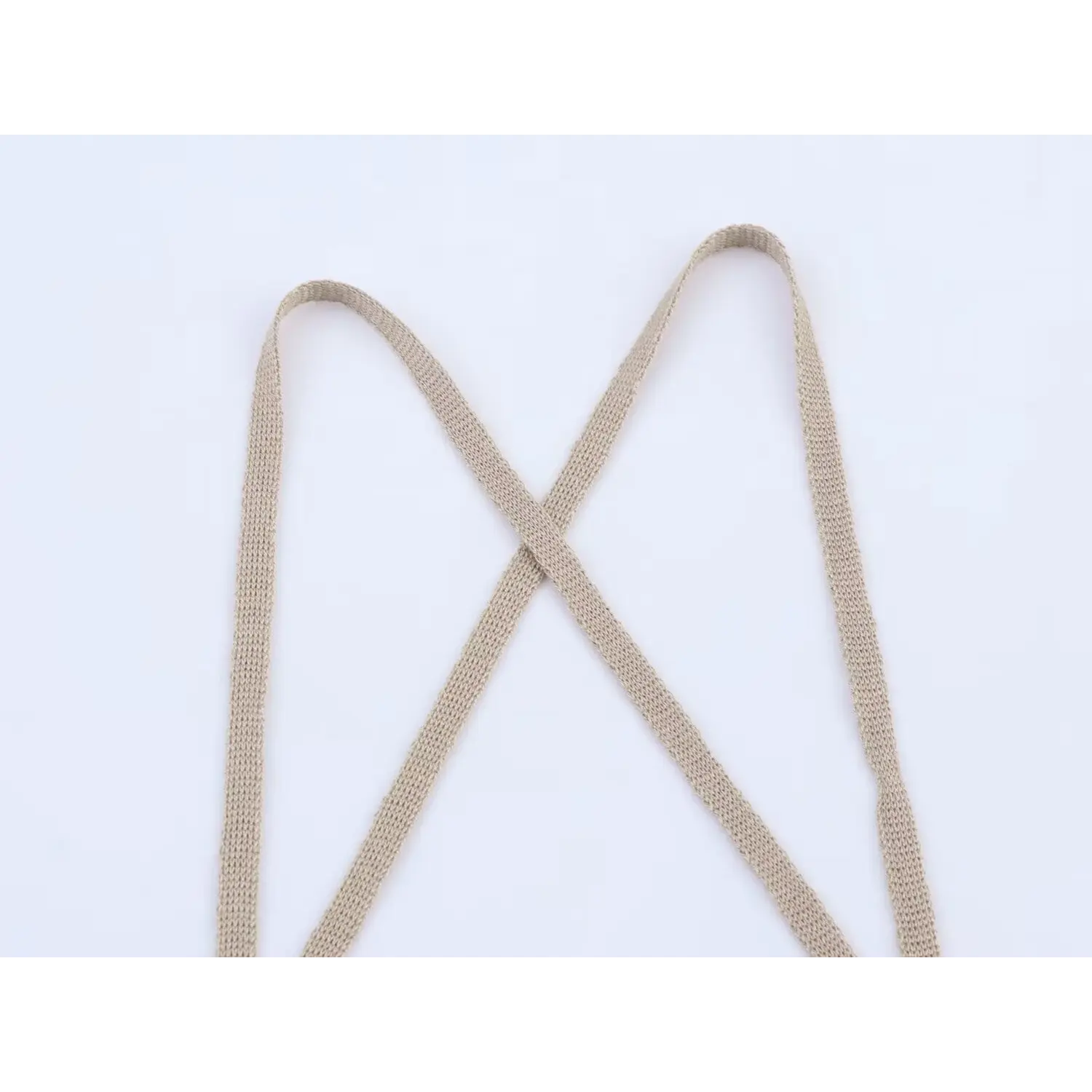 Close-up view of crisscross shoulder straps on taupe lace-up camisole top