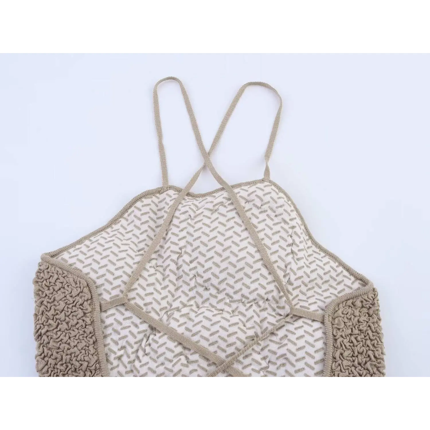 Partial back view of taupe camisole showing crisscross lace-up straps and textured knit fabric