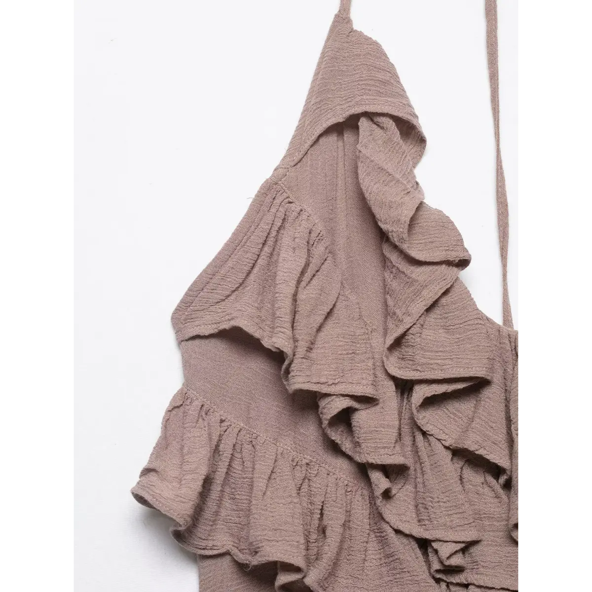 Close-up of the layered ruffles and textured fabric on the taupe halter mini dress