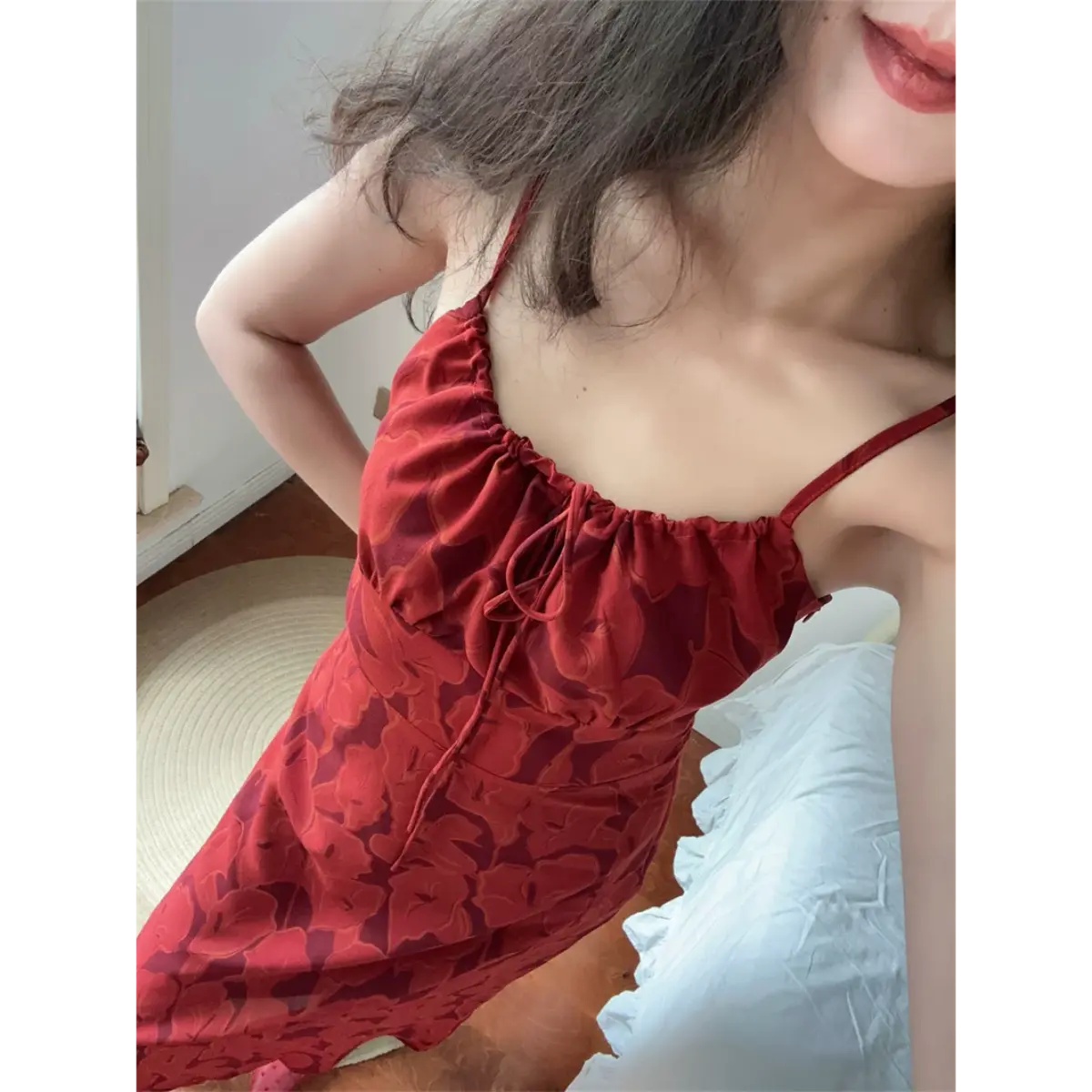 Upper body close lifestyle shot of red big leaf print slip dress, highlight front self-tie drawstring detail and adjustable thin straps.
