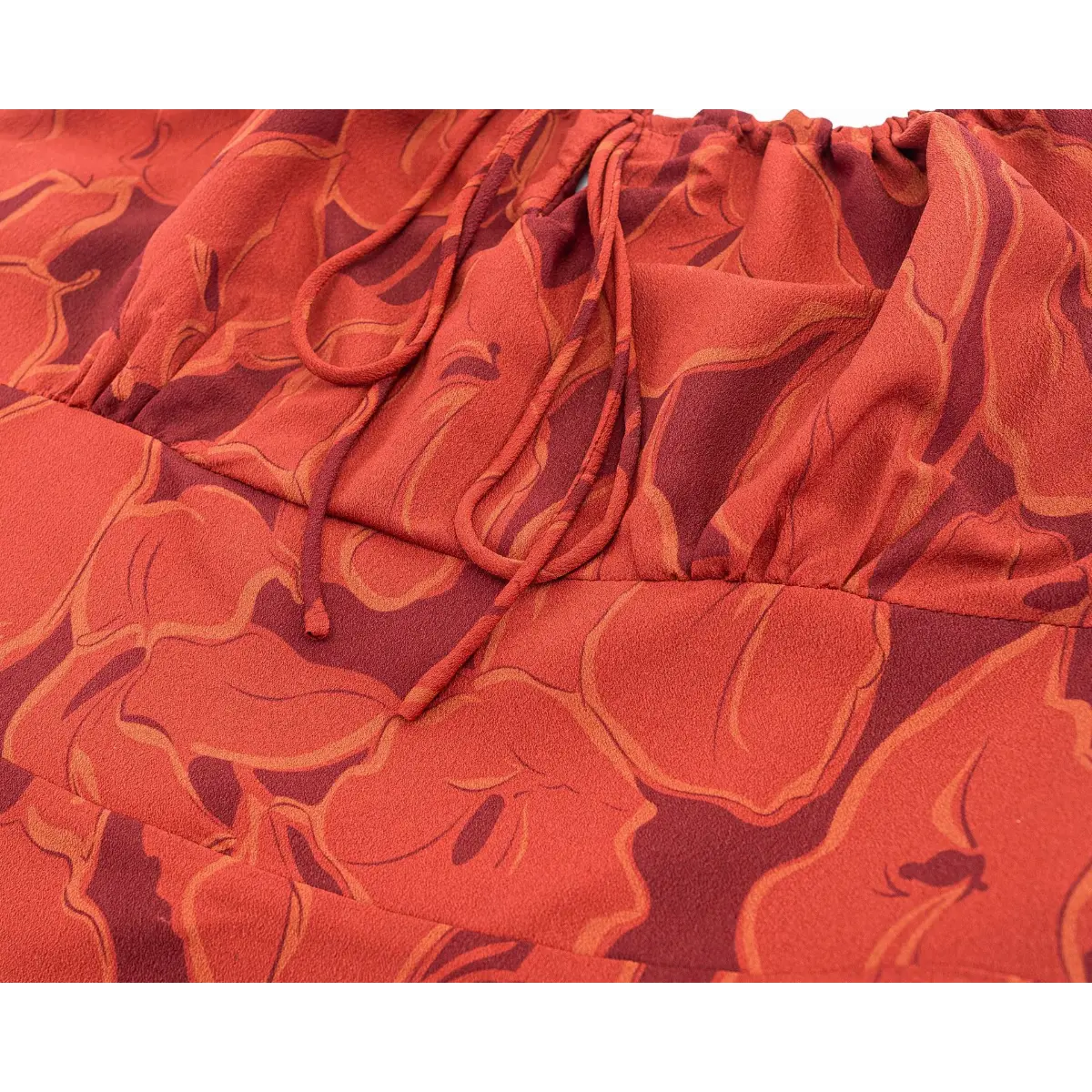 Back view lifestyle picture of terracotta floral midi slip dress, highlight elastic smocked waist and open back design.