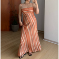 Indoor mirror full shot of cream base terracotta vertical gradient stripe slip maxi dress, thin adjustable spaghetti straps, fitted empire waist, paired with simple black square slide sandals