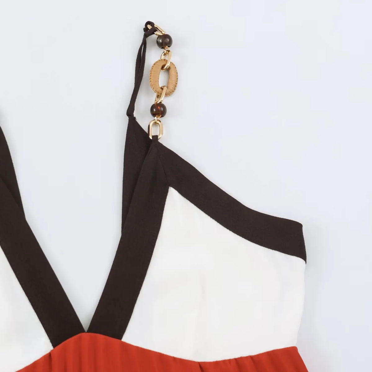 Partial shot of metal chain strap attached to color‑block shoulder
